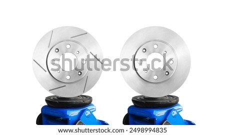 Slotted brake rotor and solid brake rotor on a hydraulic car jack isolated on white background , Car parts concept