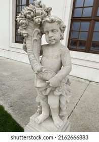 Slovakia Bratislava 31.05.22 Handmade Beautiful Detailed Stone Statue Of Child Holding Flowers In The Park