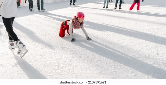 Slovakia.Bratislava.28.12.2018 .Soft,Selective Focus.Winter Sport.People Ice Skating On The City Park Ice Rink The Child Fell On The Rink While Skating.