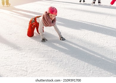 Slovakia.Bratislava.28.12.2018 .Soft,Selective Focus.Winter Sport.People Ice Skating On The City Park Ice Rink The Child Fell On The Rink While Skating.