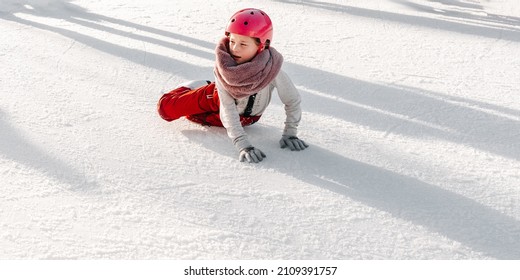 Slovakia.Bratislava.28.12.2018 .Soft,Selective Focus.Winter Sport.People Ice Skating On The City Park Ice Rink. The Child Fell On The Rink While Skating.