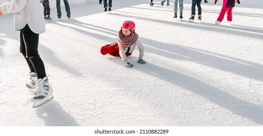 Slovakia.Bratislava.28.12.2018.Soft,Selective Focus.Winter Sport.People Ice Skating On The City Park Ice Rink The Child Fell On The Rink While Skating.