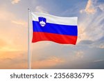 Slovenia flag waving on sundown sky