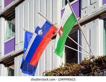 Slovenian Flag, Ljubljana Flag And EU Flag On Building In Ljubljana Old Town Streets, Slovenia In Evening. Slovenian City View In Spring. Landmark. Urban Green Capital.