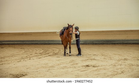 A Slovenian Girl With A Horse In An Equestrian Arena