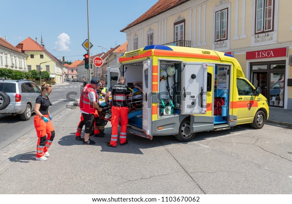 Slovenska\
Bistrica, Slovenia - June 2 2018: Rescuers load patient into\
ambulance car. Emergency Services Workers train in joint action\
with Rescuers, Firemen, Police and Red\
Cross.