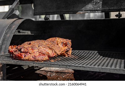 Slow Cooked Beef Brisket Meat On The Grill Grates Of A Smoker Barbecue