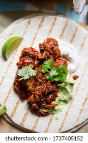 Slow Cooked Chipotle Chicken On Tortilla With Guacamole And Sour Cream