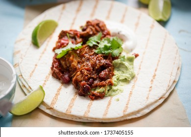 Slow Cooked Chipotle Chicken On Tortilla With Guacamole And Sour Cream