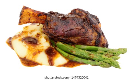 Slow Cooked Lamb Shank Meal With Creamy Mashed Potato And Asparagus Isolated On A White Background