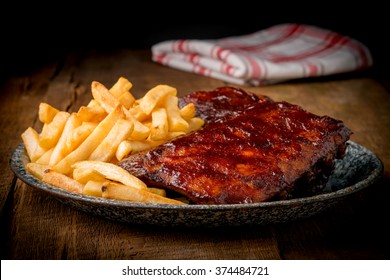 Slow Cooked Pork Baby Back Ribs With French Fries.