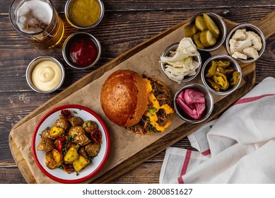 Slow cooked pulled rib beef burger with melted cheese and sides