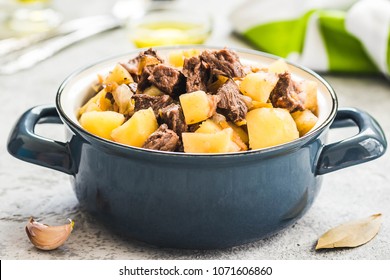 Slow cooker beef potato stew in a pot on concrete background. Selective focus, space for text. 