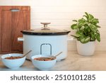 Slow cooker and bowls of vegetarian chili on a kitchen counter