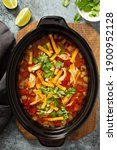 Slow cooker chicken taco soup topped with fresh cilantro