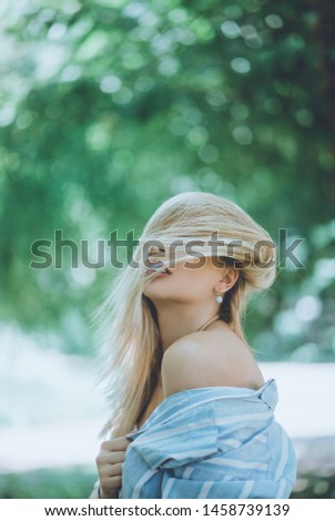 Similar – Blonde woman with black dress and sunglasses performing dance in nature with backlight