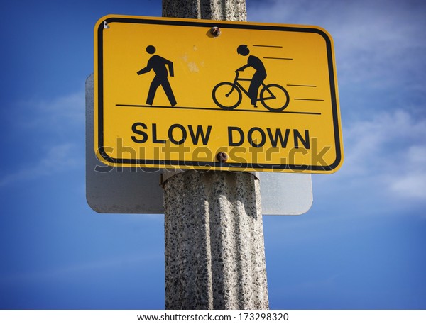 slow down road sign with\
bicycle