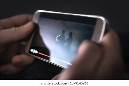 Slow internet, video load and download speed. Watching movie online. Loading icon on screen. Frustrated angry person with poor and bad broadcast connection for entertainment. Man with mobile phone. - Shutterstock ID 1399145966