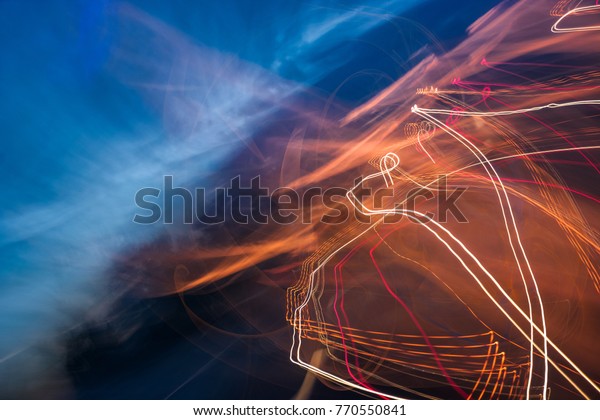 slow motion abstraction on the road. blurred\
background of car light traces and cloudy night sky. traffic wild\
energy concept