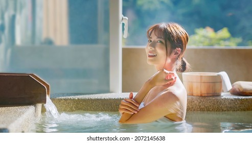 Slow Motion Of Asian Young Woman Touch Her Shoulder While She Relaxing Sitting In Hot Spring