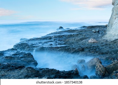 Slow Motion Captures The Artistic Look And Feel Of The Ocean Water As It Hugs A Reef During Daybreak. 