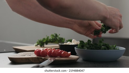 Slow Motion Man Hands Massage Kale Leaves In Blue Bowl On Concrete Surface, 60fps