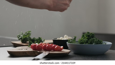 Slow Motion Man Hands Tear Kale Leaves In Blue Bowl On Concrete Surface