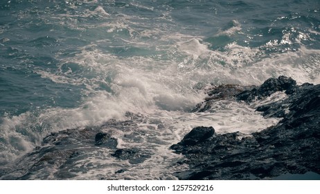 Slow Motion Shot Of Sea Waves Splashing On Coastal Rocks