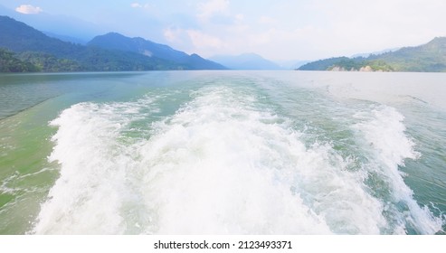 Slow Motion Video - Trace Tail Of Boat On Water Surface With Mountains