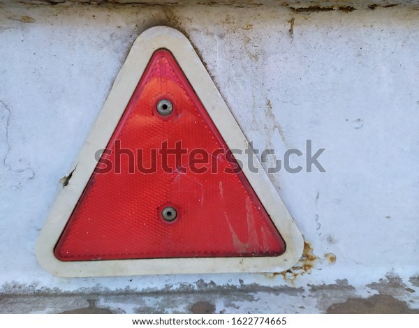 Slow moving vehicle sign. triangle sign\
that lights up when it is exposed to\
light