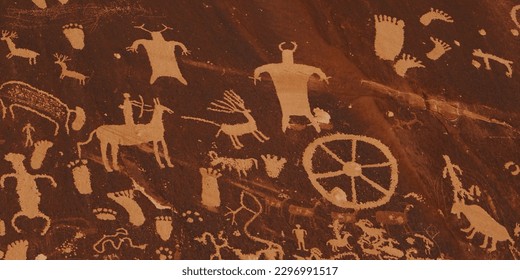 Slow pan and tilt to showcase the numerous individual petroglyphs and demonstrate the vast age differences, 500 year-old panels inscribed over 2000 to 4000 year-old symbols at Newspaper Rock in Utah.