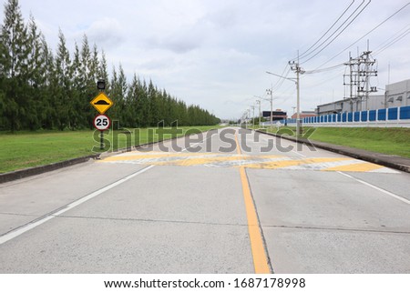 Warning​ sign​ in​ the​ speed​ slow road.