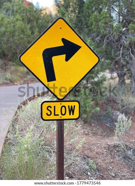 Slow Sign Sharp Turn Right with Arrow Wooden
Marker Outdoors on Road Trail
Path