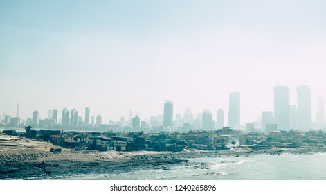 Slum Under The  Pollution Of The Skyscraper Skyline In Mumbai, India