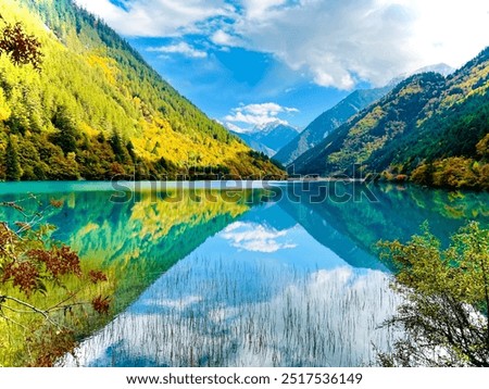 Sly blue ,lake , mountain ,white clouds, reflection in water,
paradise