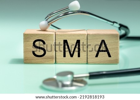 SMA, spinal muscular atrophy, Written on wooden blocks, a rare disease in which, due to a genetic defect, neurons in the spinal cord responsible for muscle contraction and relaxation gradually die.