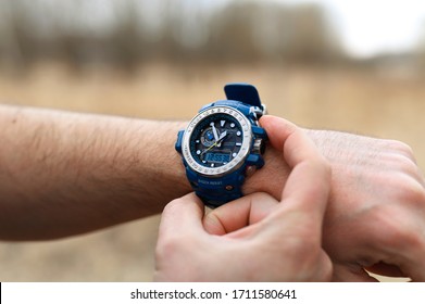 Smakhtino / Russia - April 2020: Casio G-shock GWN-1000 watches blue color from the electronics manufacturer company Casio. Men's wrist watch on the male hand of a traveler who is on a trip