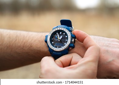 Smakhtino / Russia - April 2020: Casio G-shock GWN-1000 watches blue color from the electronics manufacturer company Casio. Men's wrist watch on the male hand of a traveler who is on a trip