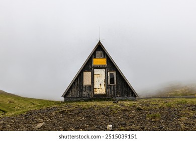 Small abandoned a frame wooden hut standing on  foggy day - Powered by Shutterstock