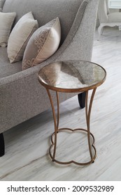 Small Accent Table Made Of Gold Metal With Mirror Top In The Living Room