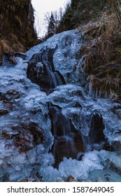 A small active waterfall. Clean mountain stream, snowy winter landscape, wildlife background