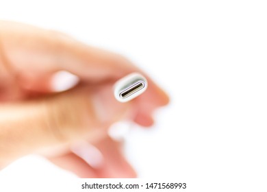 A small adapter from USB type-c connector 3.5 jack on the man's hand. Isolated on white background. SOFT focus. Small DOF