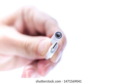 A small adapter from USB type-c connector 3.5 jack on the man's hand. Isolated on white background. SOFT focus. Small DOF
