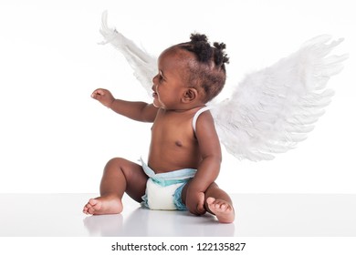 A Small African Baby With Her Angel Wings On The Back And A Nappy On.