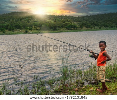 small african child with around fishing in the waters of a lake in the bush