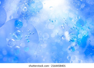 Small air bubbles in a bottle immersed in the sea. Blue abstract background. Illuminated liquid surface. Macro photo. - Shutterstock ID 2164458401