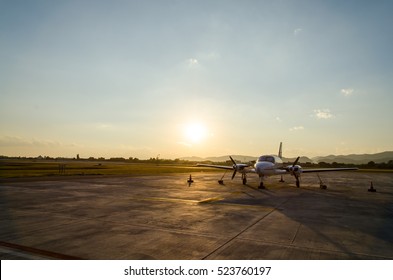 Small Airplane or Aeroplane Parked at Airport.Small Airplane Famous to use Private Airplane.Sunset Light and Mountain View.