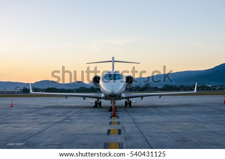 Small Airplane or Aeroplane Parked at Airport.Small Airplane Famous to use Private Airplane.Sunset Light and Mountain View.
