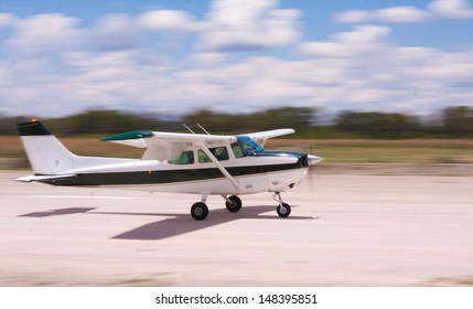 Small Airplane Landing On A Gravel Air Strip With Motion Blur To Convey Movement