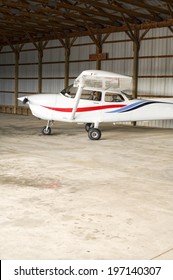 A Small Airplane In A No Smoking Hangar.